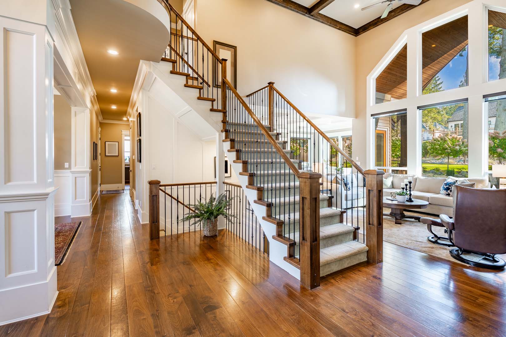 Interior living room with fireplace stone and wood mantle staircase wooden flooring